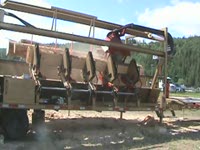 Twin-Cut Portable sawmill sawing and turning logs