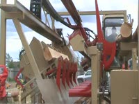 Automated portable sawmill handles waste and lumber easily